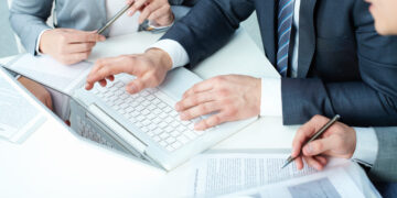 Group of business people working with laptop at meeting