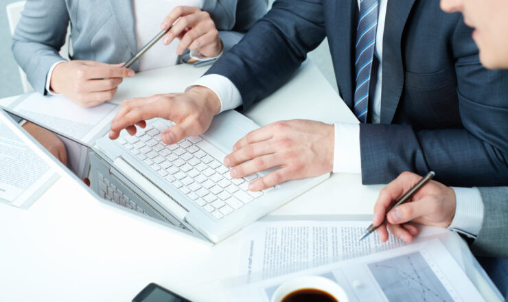 Group of business people working with laptop at meeting